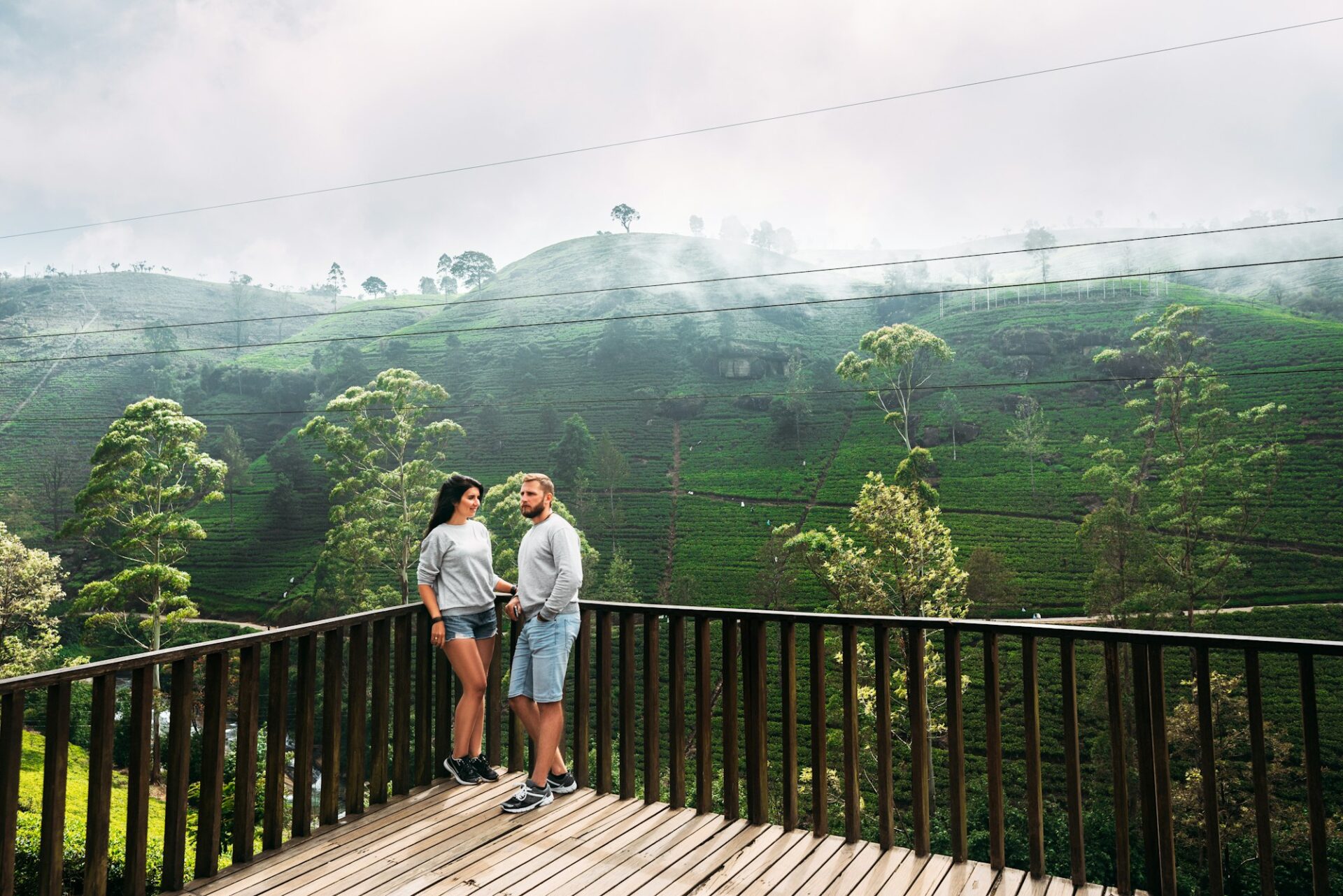 Couple in love at tea plantation. Travel to Sri Lanka. Green tea plantations in the mountains