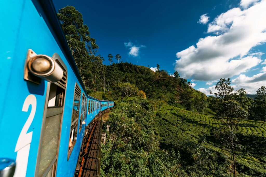 Train from Nuwara Eliya to Kandy among tea plantations in the highlands of Sri Lanka